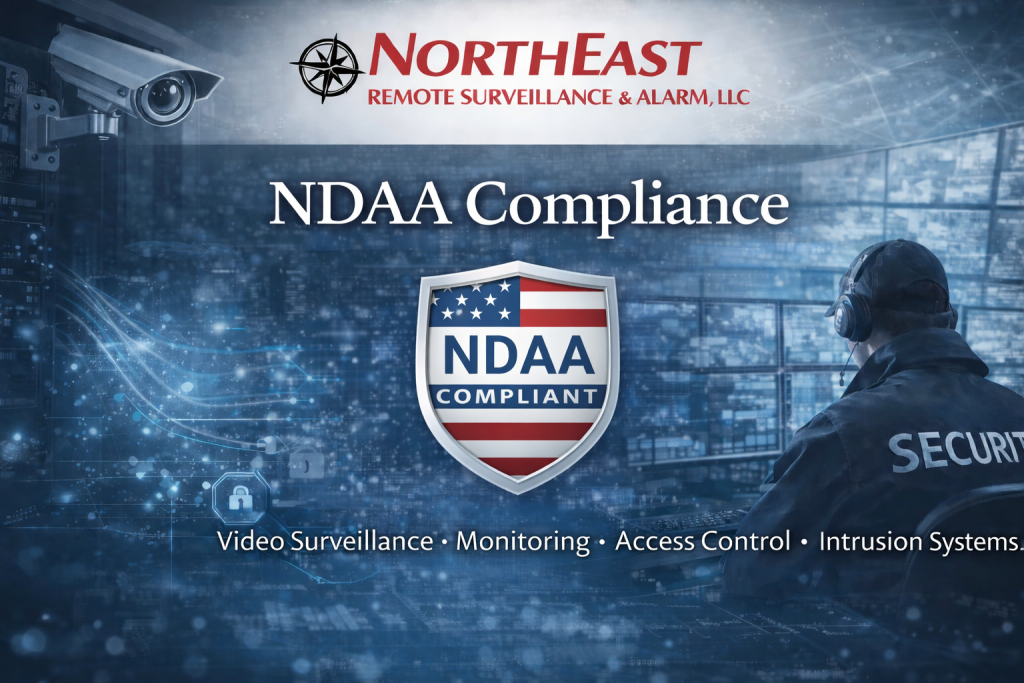 NDAA Compliance banner for Northeast Remote Surveillance and Alarm, LLC featuring company logo, NDAA compliant shield emblem, surveillance monitoring center background, and security professional in control room.