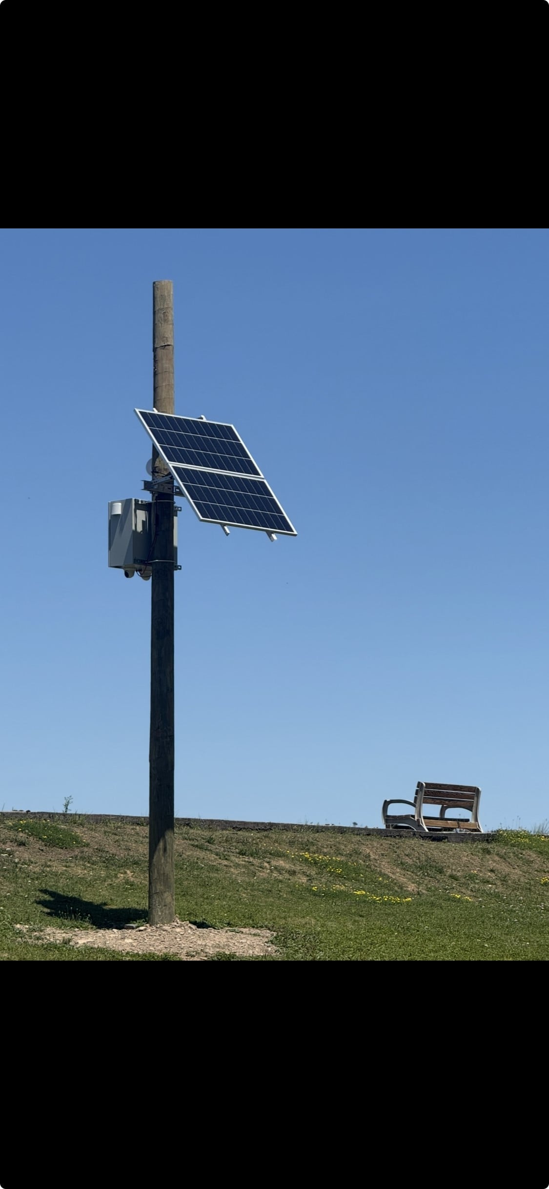 Custom engineered solar-powered security camera overlooking the Pocono Springs lake spillway