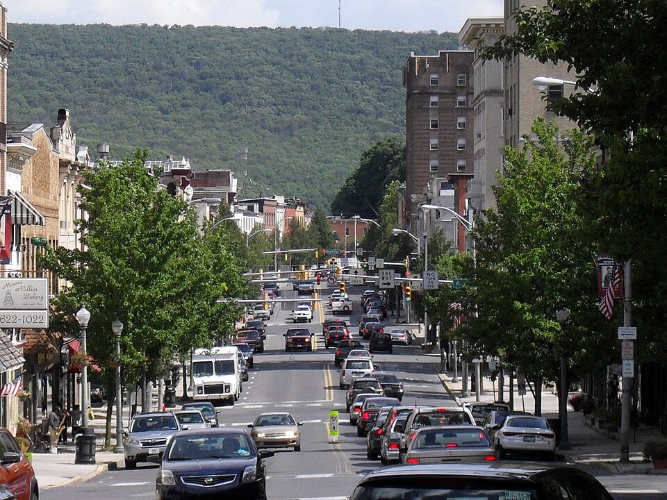 Downtown Pottsville, Pennsylvania, with commercial buildings and wooded hills