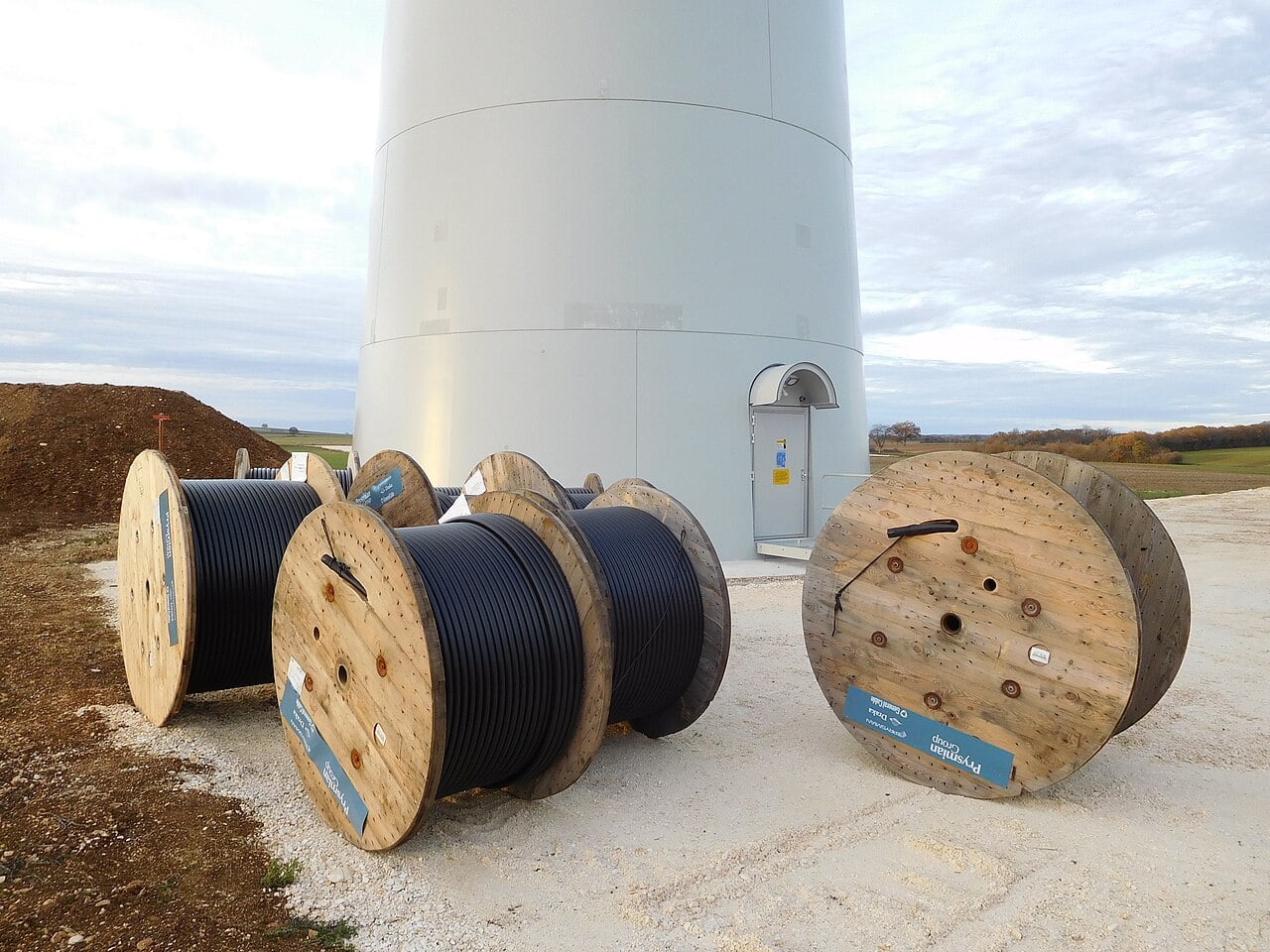 Prysmian cable drums beside a wind turbine in Pougny, France
