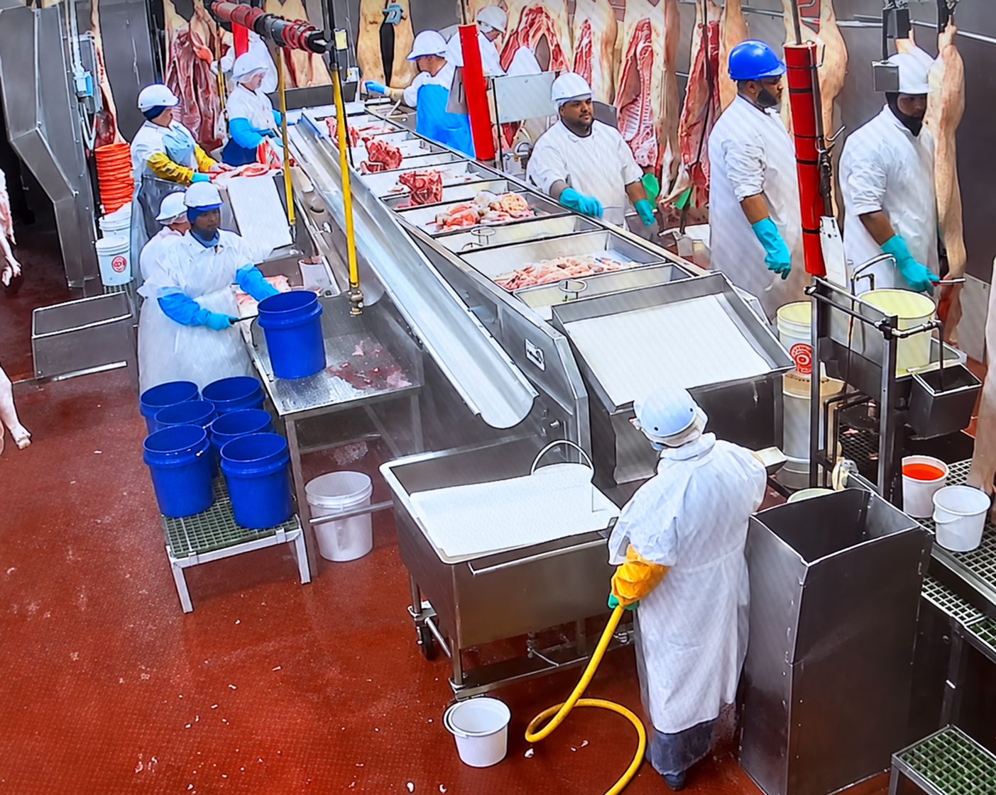 Enhanced customer-supplied image showing employees and processing equipment at USA Pork Packers in Hazleton, Pennsylvania.