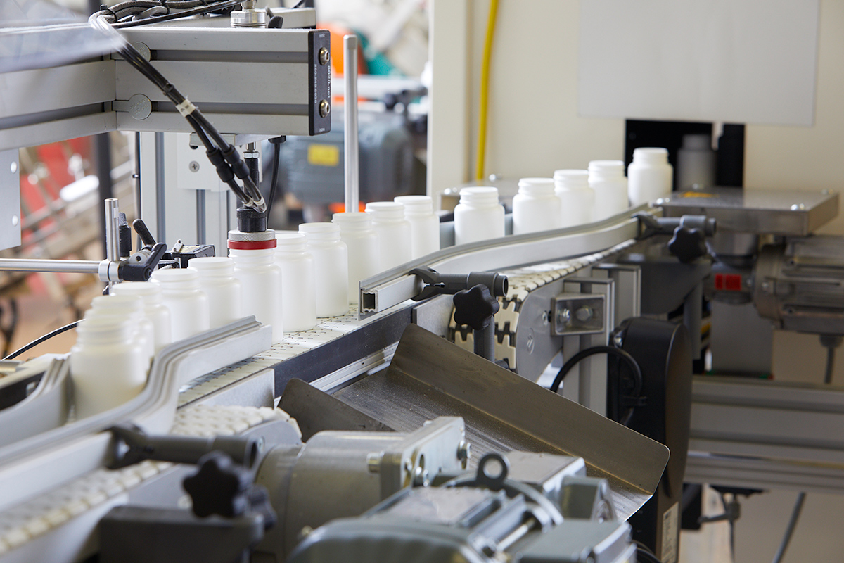 Manufacturing-line photograph published by Drug Plastics and Glass